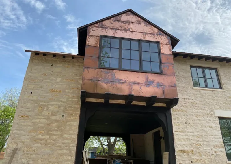 Copper metal panel facade on a stone building for Roof Repair in Wichita Falls
