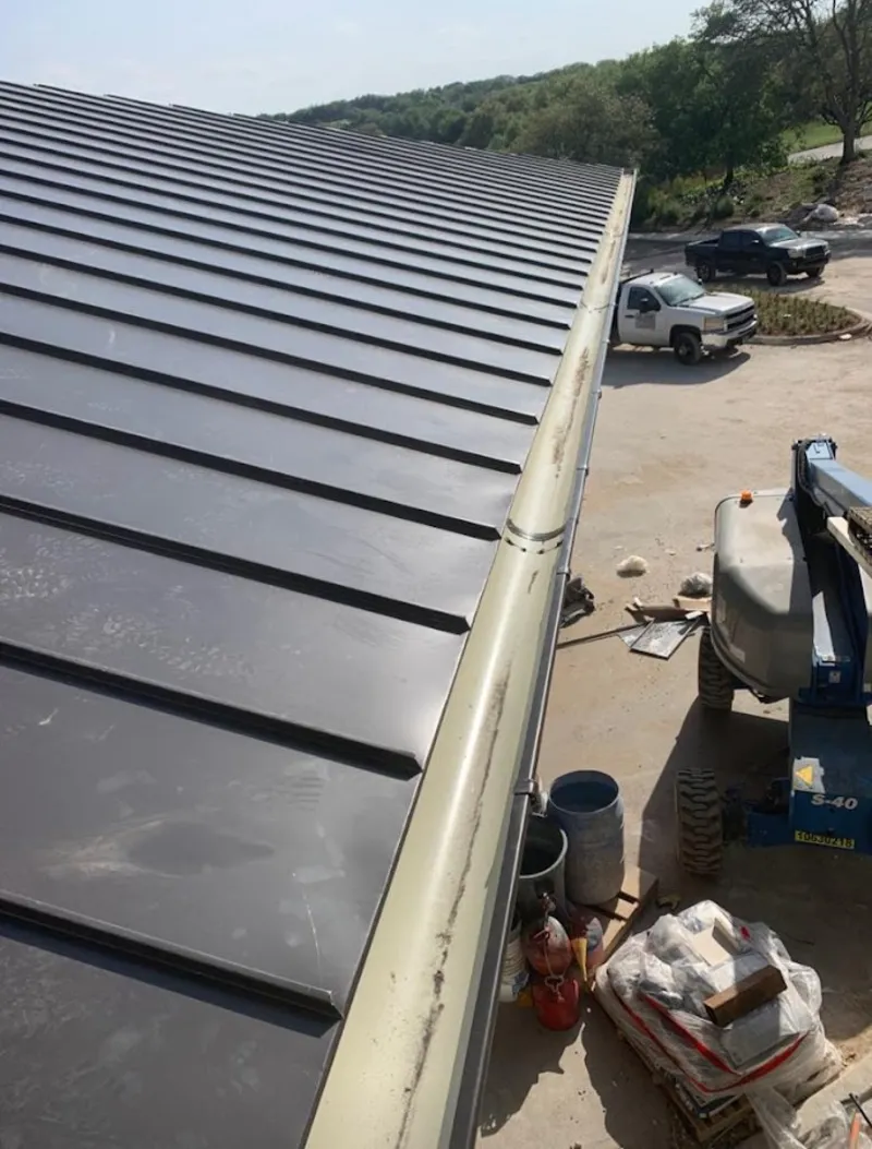 Standing seam panel and gutter detail on a metal roofing jobsite in Wichita Falls